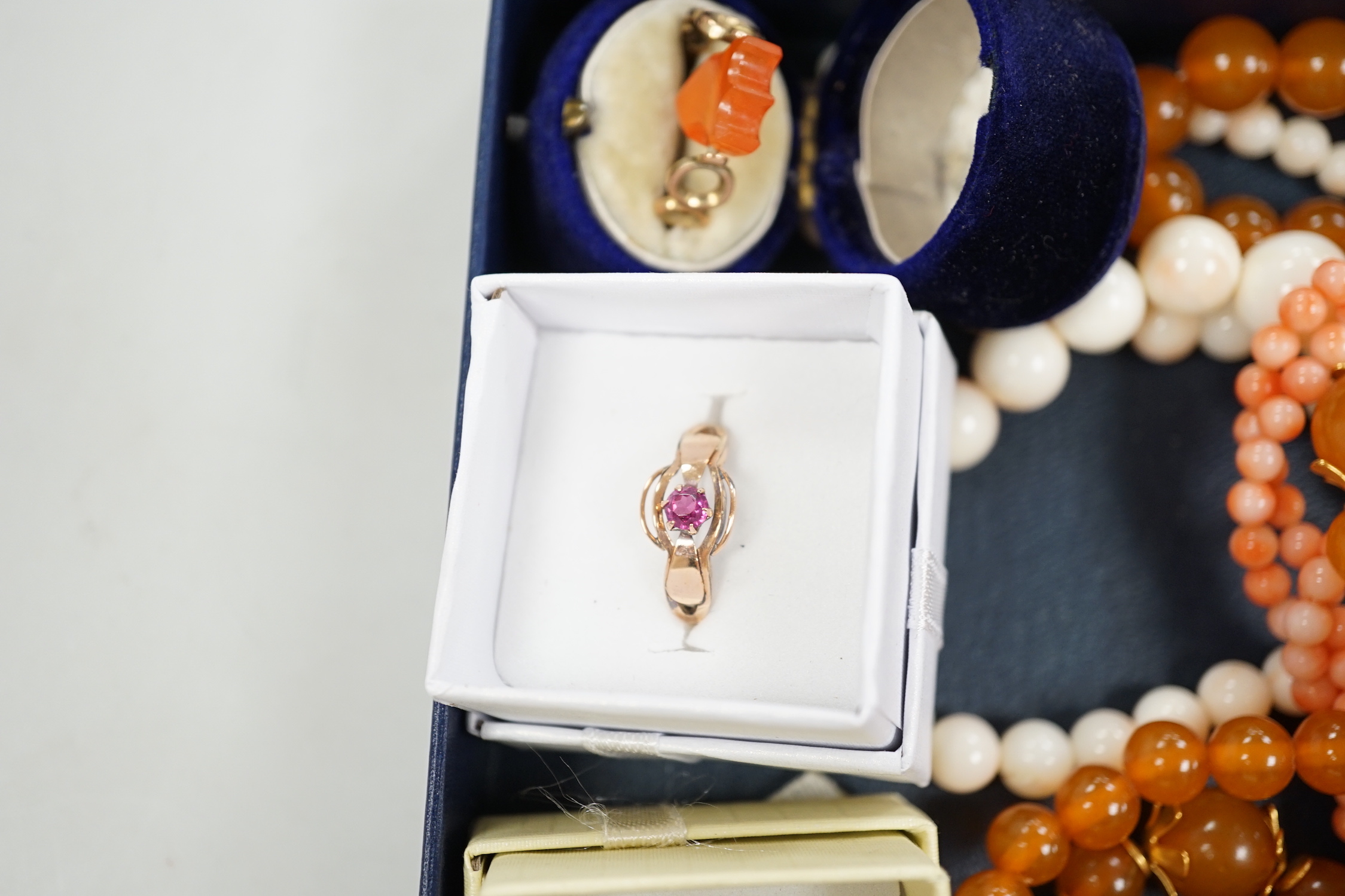 A 9ct and opal doublet ring, two other 9ct and gem set rings, an Edwardian yellow metal and swivelling carnelian ring and six assorted necklaces.